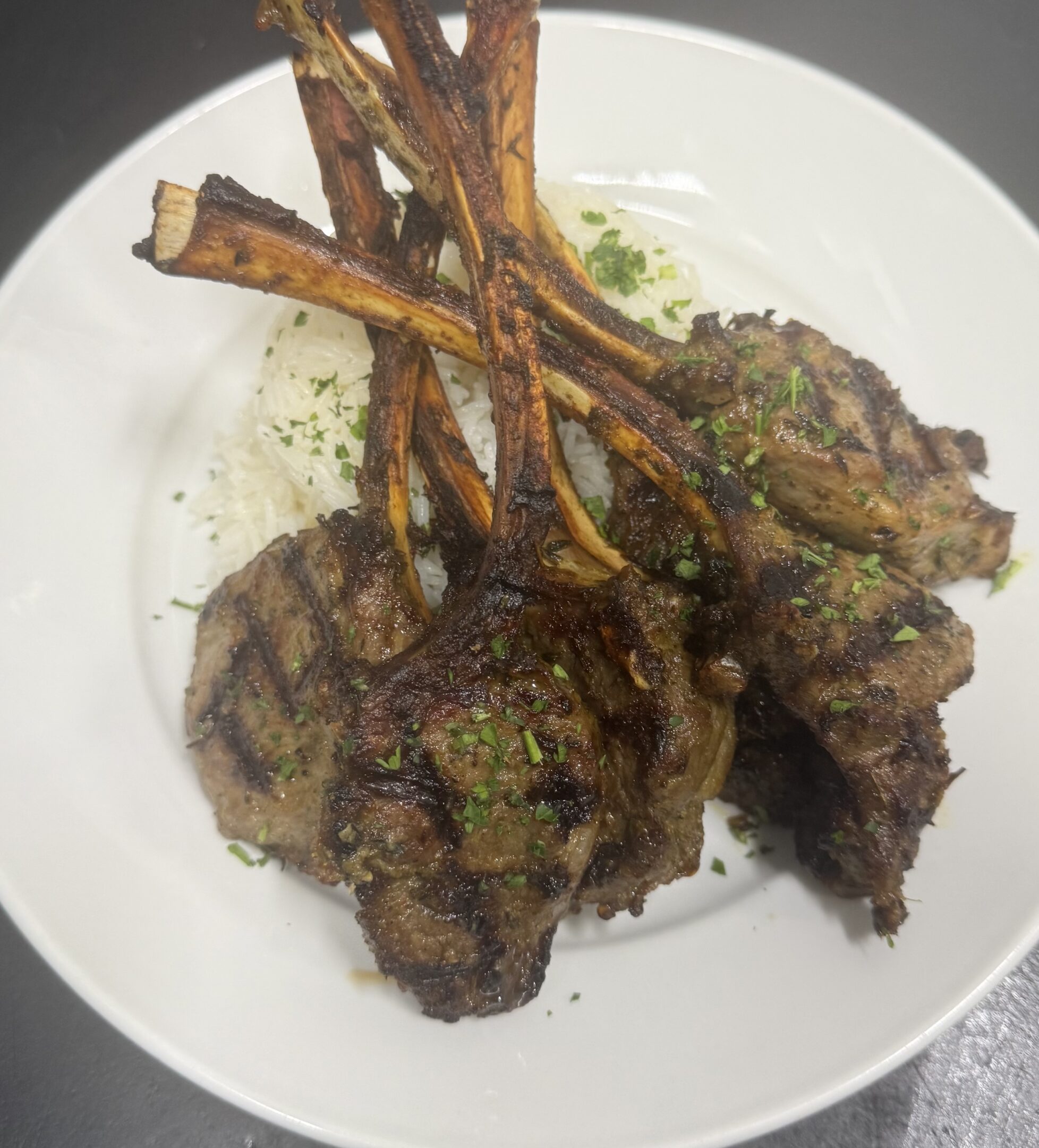 Grilled lamb chops served over rice