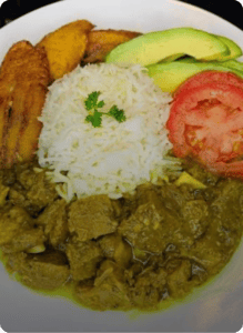 White rice with green stew, avocado, plantains